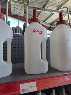 three jugs that are on the shelf in the store