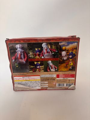 La boîte de la figurine représente un homme vêtu d'un costume rouge.