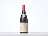 a bottle of red wine sitting on top of a table