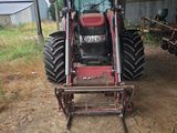 a tractor that is parked in front of a building
