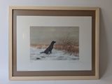 painting of a dog in the snow in a frame hanging on a wall