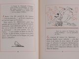 an open book with a drawing of a bird on it