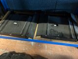 two metal trays that are sitting on the floor