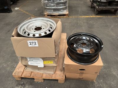 two rims and a wheel on a pallet in a warehouse