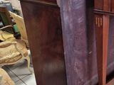 a piano sitting in the middle of a room next to a table