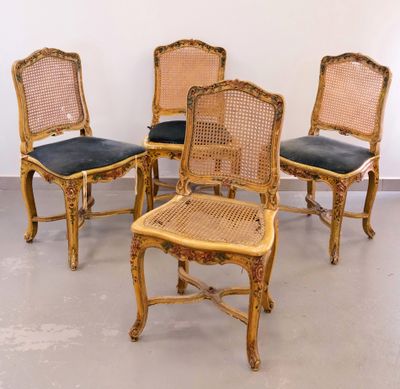 four chairs are lined up in a row in a room