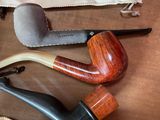 a lot of different types of smoking pipes on the table