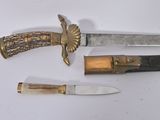 two knives and a knife holder on a white surface