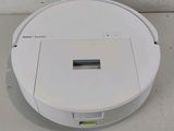 an image of a robotic vacuum cleaner on a white surface