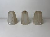 three clear glass vases sitting on top of a white table