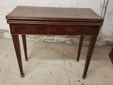 a small wooden table with a drawer on top of it