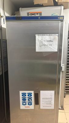 a silver refrigerator that is sitting in a kitchen