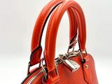 a small orange purse with a zipper on it