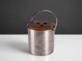 a close up of a metal container with a wooden handle