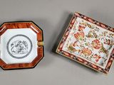 pair of small porcelain dishes with floral designs and gold rims