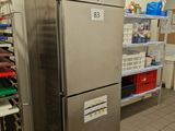 a refrigerator in a kitchen with a lot of food on the shelves