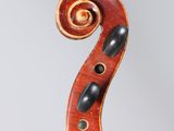 an old violin with a scroll on the back of it