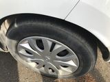 a close up of a tire on a white car