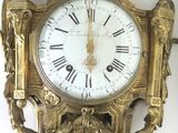 a clock that is on the wall next to a wall clock
