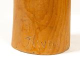 a close up of a wooden vase with writing on it