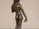 bronze statue of a woman holding a bird in her hand