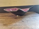 a small bowl sitting on a table in a room