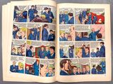 a comic book open to a page with a picture of a man in a blue uniform