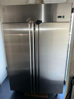a stainless steel refrigerator in a kitchen with a blue floor