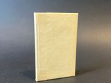 a small book sitting on top of a table next to a black background