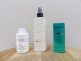 a bottle of kerastase and a bottle of olaplex on a table