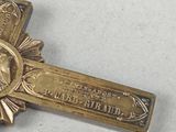 a gold cross with a picture of a woman on it