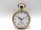 a gold pocket watch with a white face on a white background