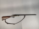 an old rifle with a wooden barrel on a white background