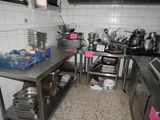 many pots and pans on the counter in the kitchen