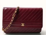 a picture of a red purse with a gold chain on it