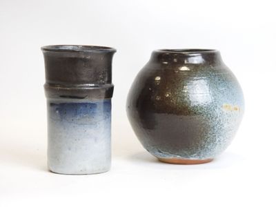 two vases sitting next to each other on a white surface