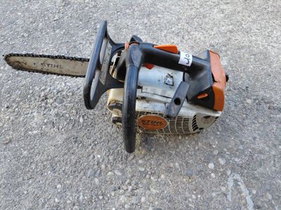 a close up of a chainsaw on the ground on the ground