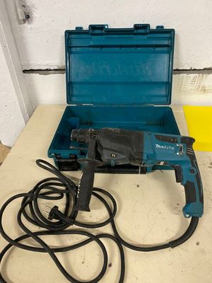 a drill and a cord in a case on a table
