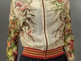 an image of a mannequin wearing a floral jacket and skirt
