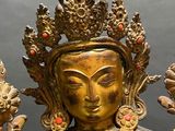 a gold statue of a woman with a crown on her head