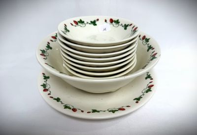 a stack of plates and bowls sitting on a white table