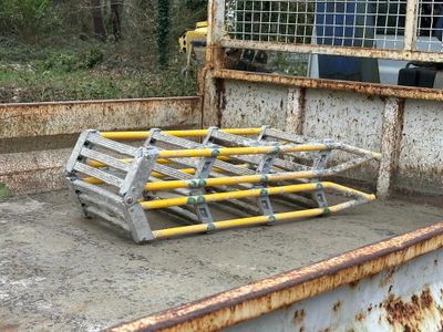 a rusty truck bed with a ladder in the back