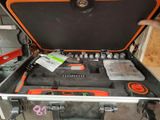 a tool case with tools in it and a person holding it