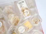 many different types of jewelry in a plastic container
