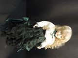 a doll that is sitting on a black surface