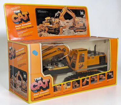 a box with a toy truck in it on a white surface
