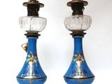 pair of blue and gold vases with glass lamps on stands