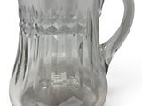 clear glass pitcher on a white background with a diamond pattern