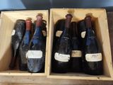 three bottles of wine in a wooden box on a table