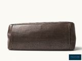 a close up of a brown toilet bag on a white background